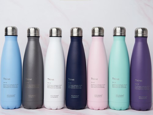 A row of seven thermos style water bottles, each one a different colour (light blue, grey, white, dark blue, pink, pale green and purple) all with silver screw-on tops.