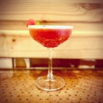 A red cocktail on a table.