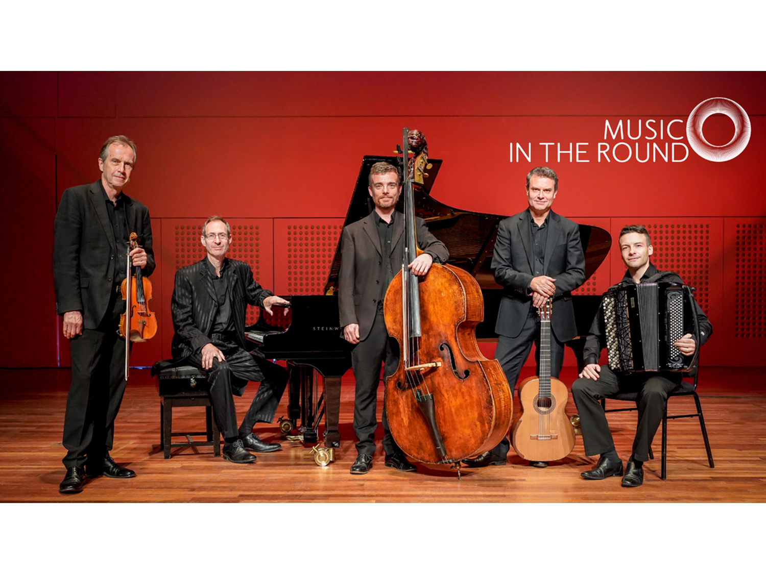 The LONDON TANGO QUINTET posing with their instruments.
