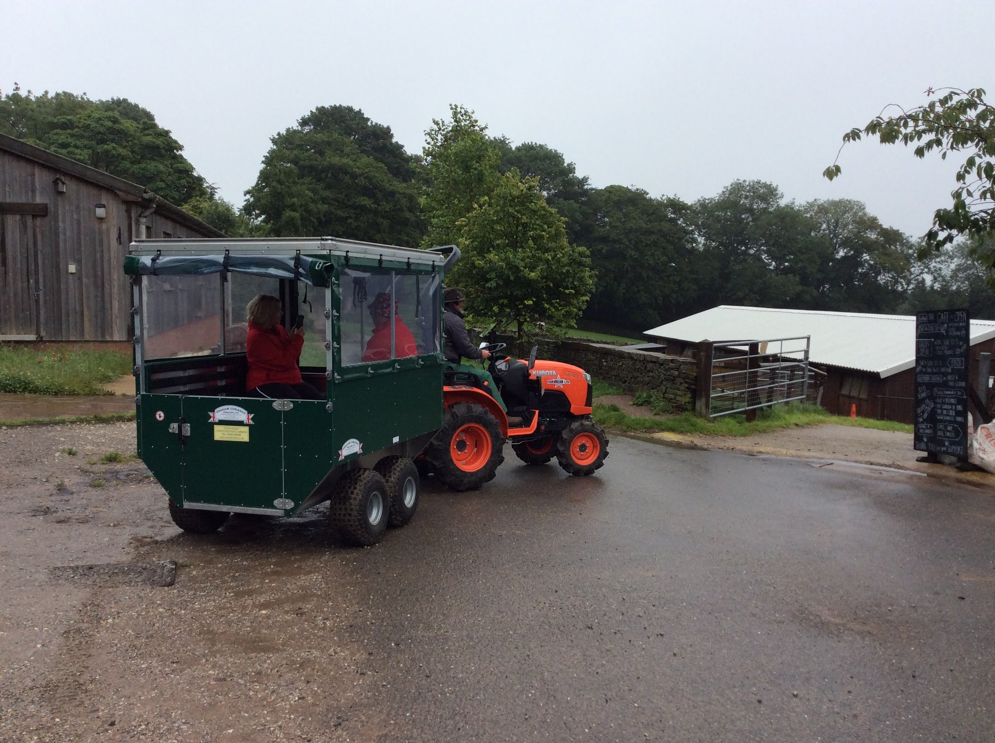 A tractor pulling a small carriage at Whirlow Hall Farm.