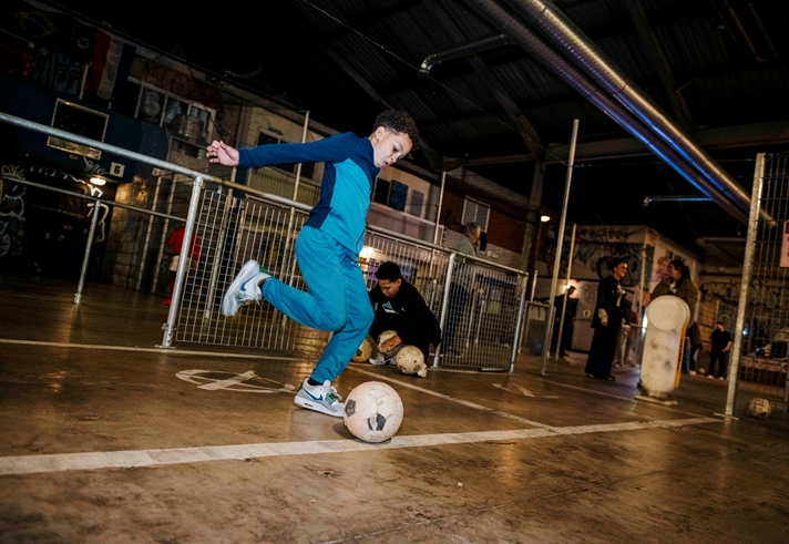 A kid playing football at Yard Ball.