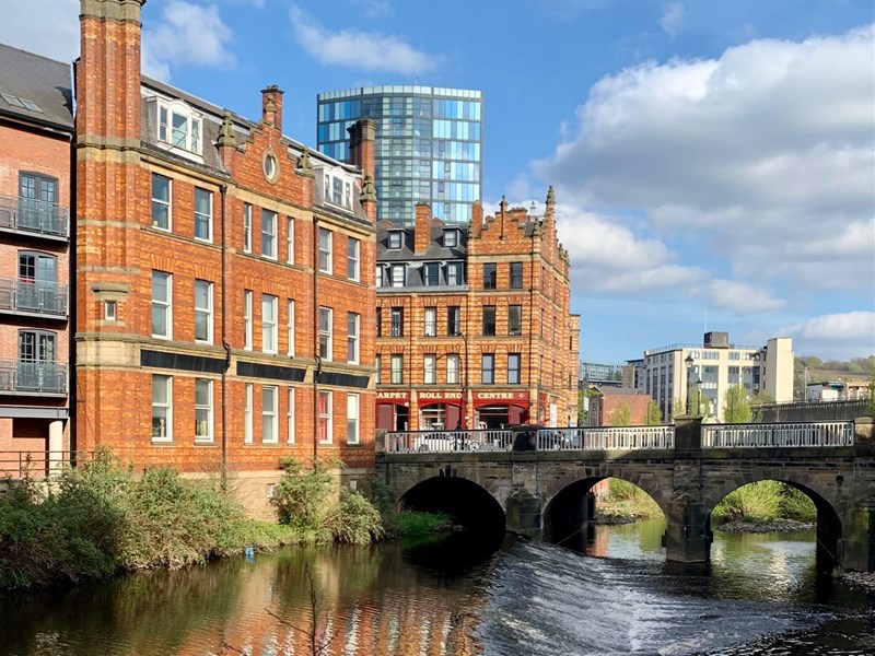 A weir on the River Don in the centre of Sheffield. In the background is Lady's Bridge.