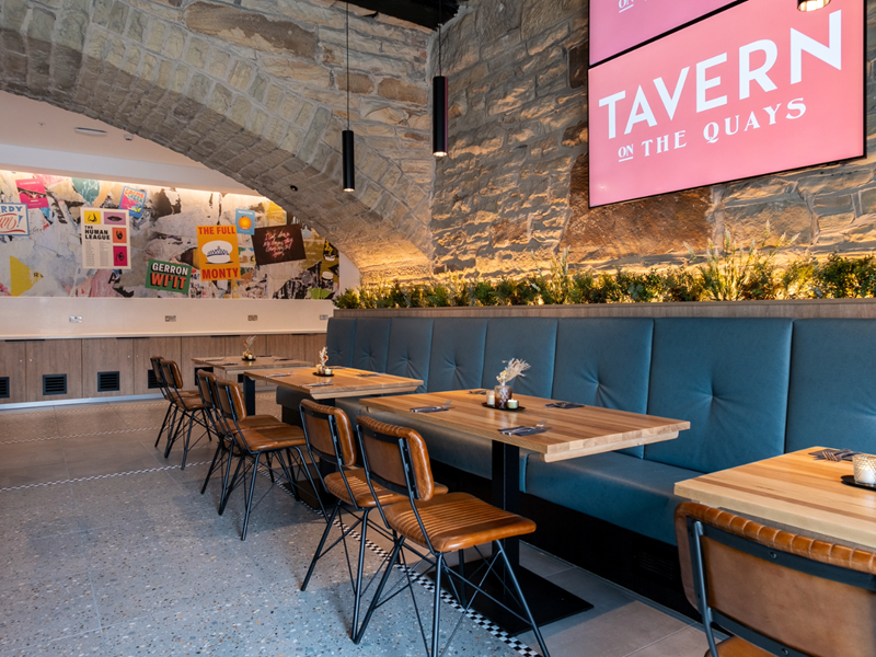 The interior of Tavern On The Quays with its bare stone walls and vaulted ceiling.