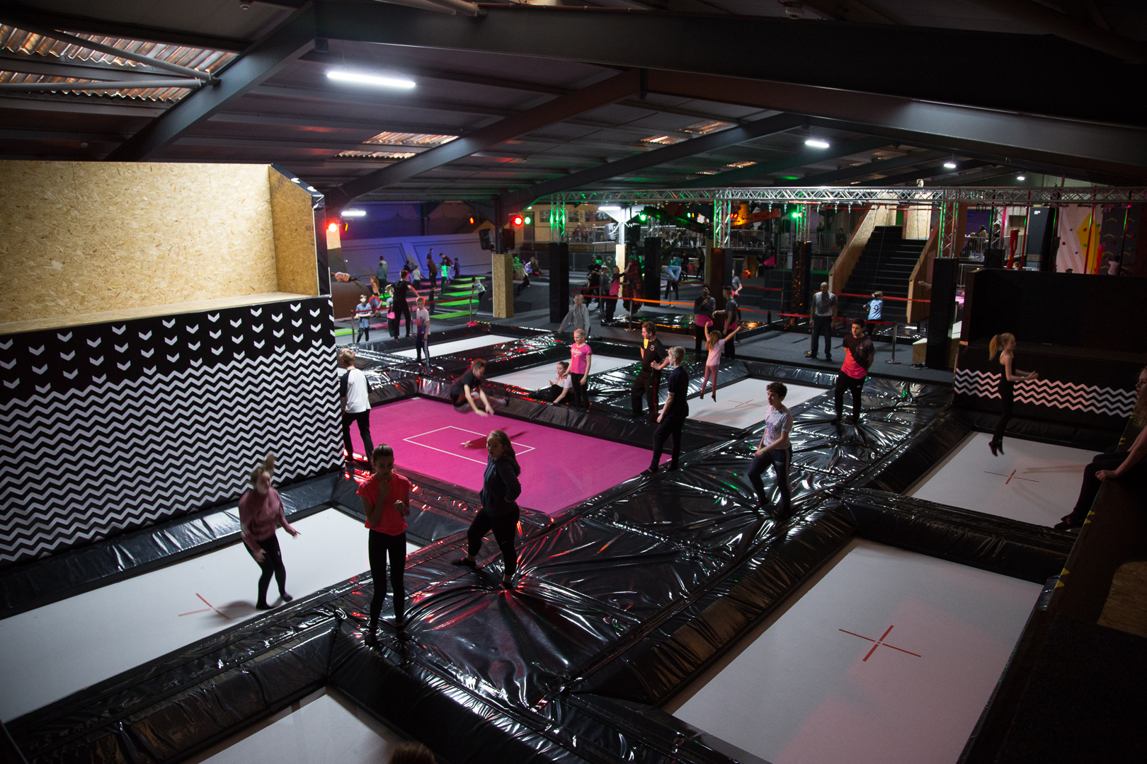 The inside of Jump Inc. with lots of young people having fun on trampolines.