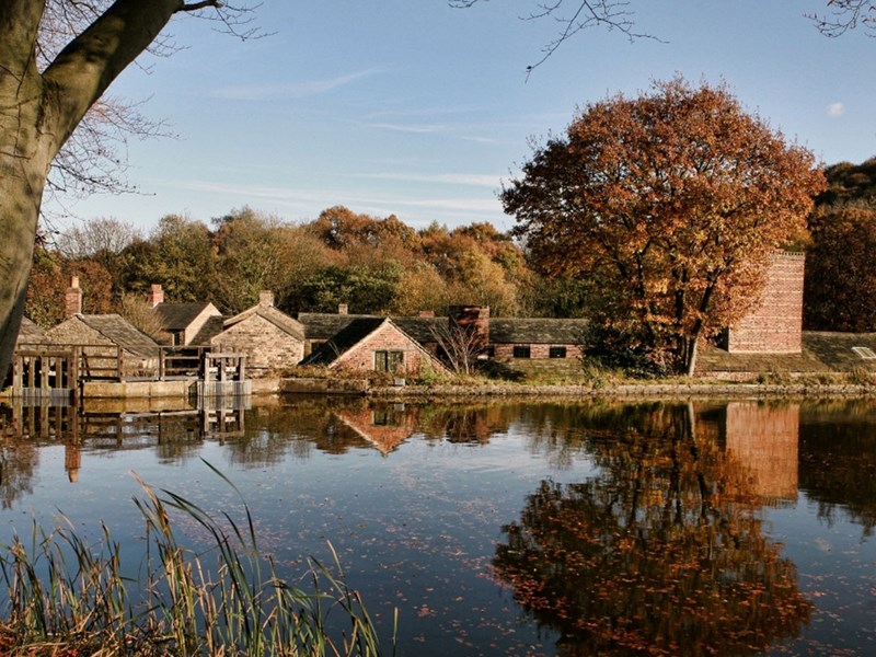A view of Abbeydale Hamlet across a pond.