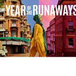 A young woman walks between two worlds, one side of the street depicts India and the other side, Sheffield.