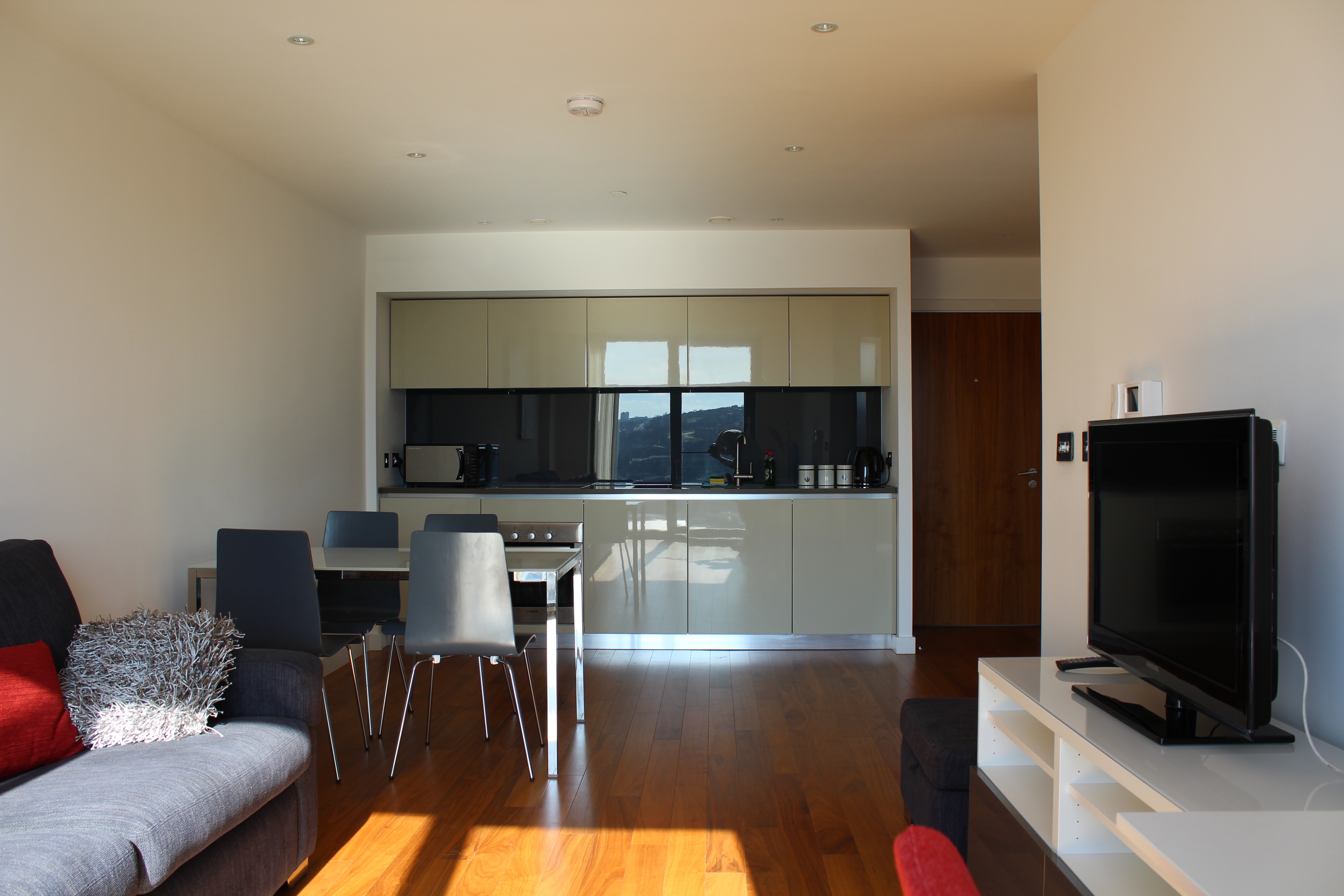 Living area with compact kitchen at Homely Serviced Apartments – St. Paul’s.