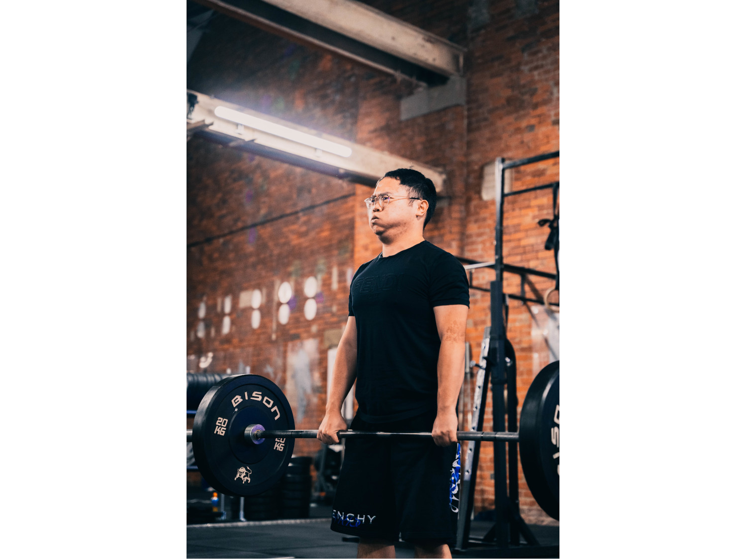 A man lifting weights at a gym.