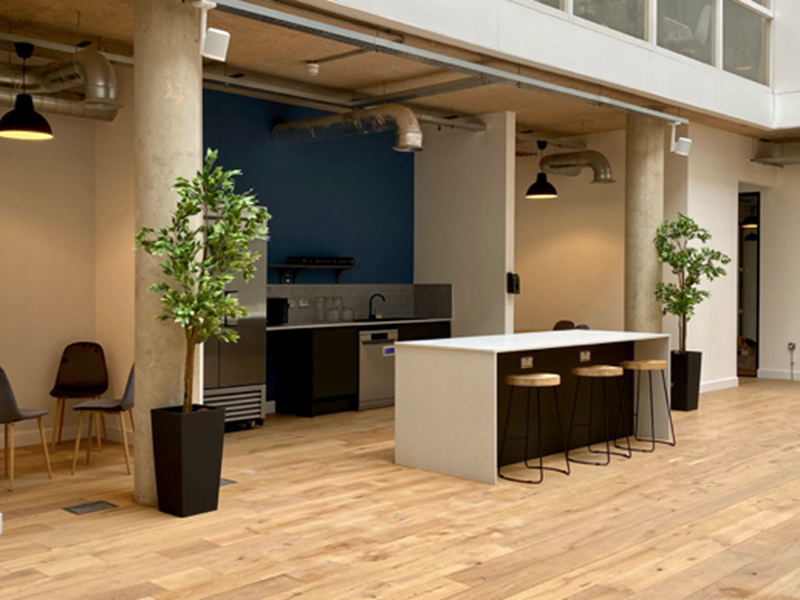 An interior shot of Cubo showing a kitchen area with free-standing worktop with three high stools.