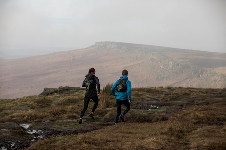 Two people on a city limits run route to Stanage Edge.