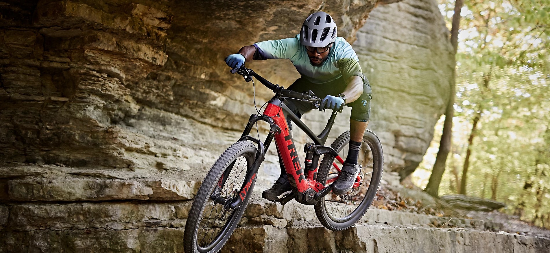 A man jumping off a rocky outcrop on a mountain bike at Trek Bicycle Sheffield Fox Valley.