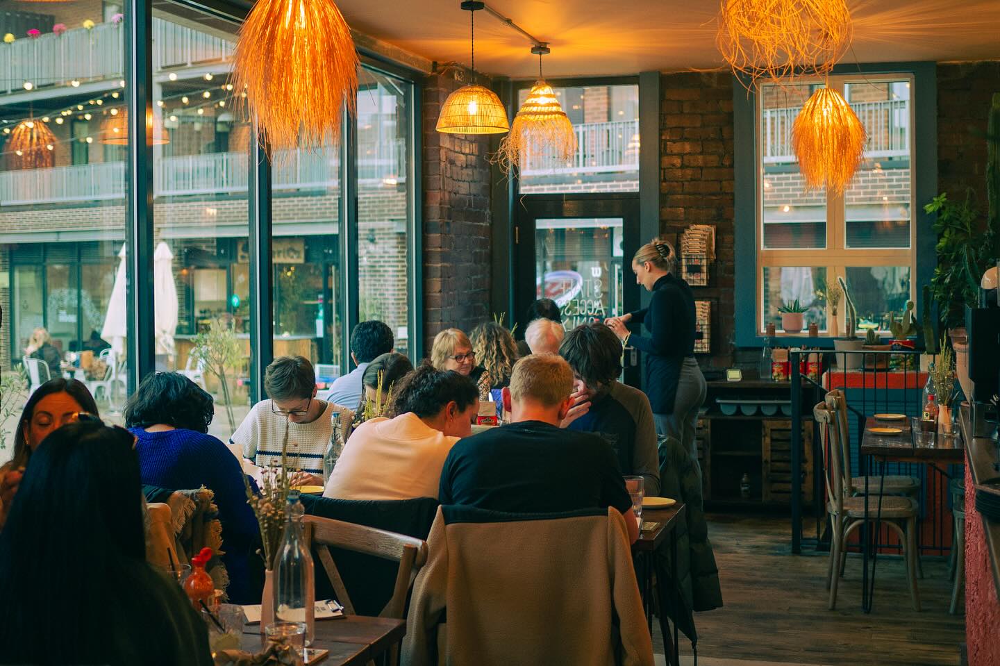 Several tables full of people enjoying their meals at Pellizco.