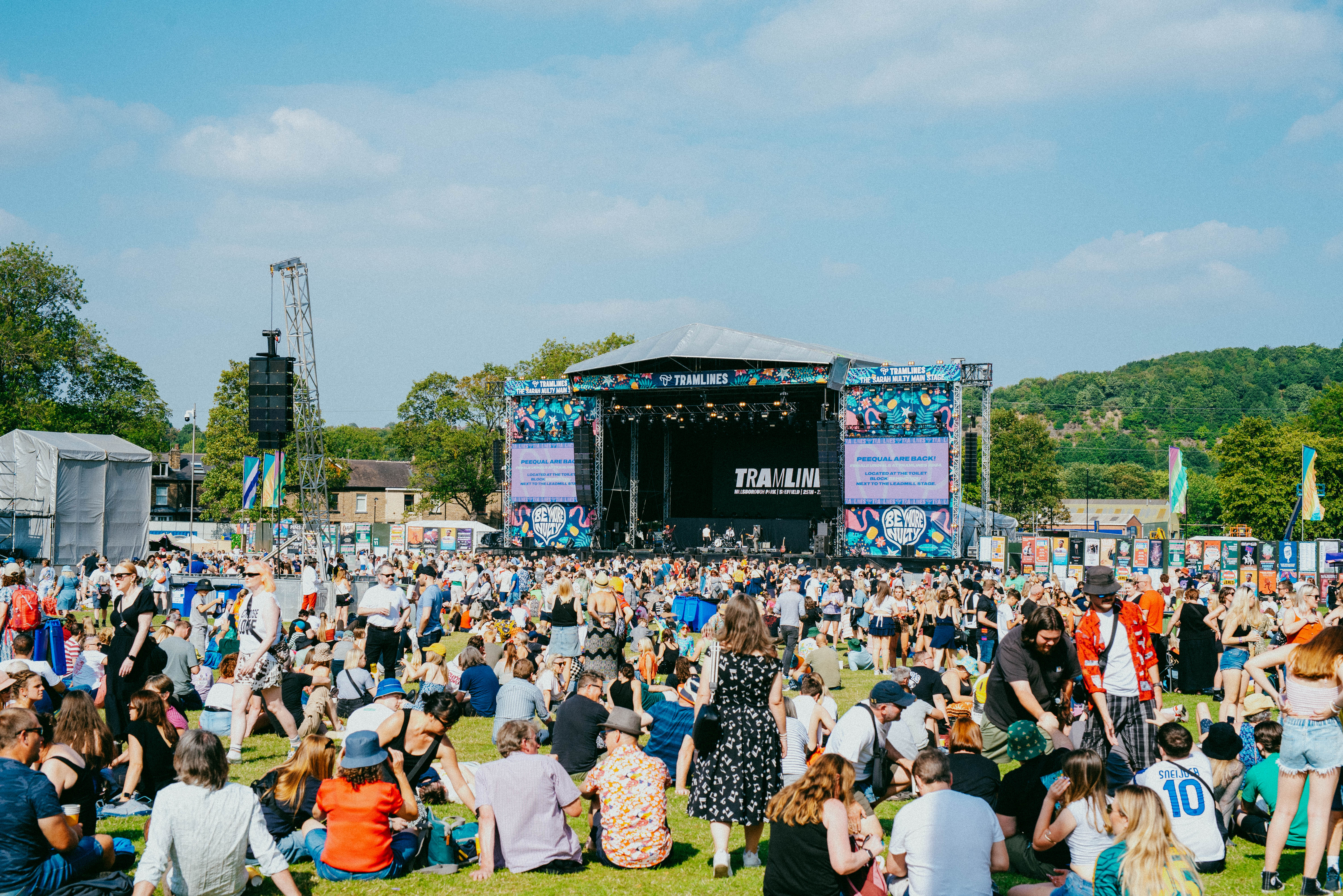 View from the back of the crowd sat out in front of the Tramlines main stage on a sunny summer's day 