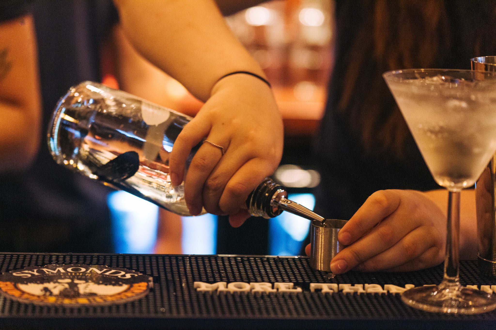 A cocktail being mixed on a bar.