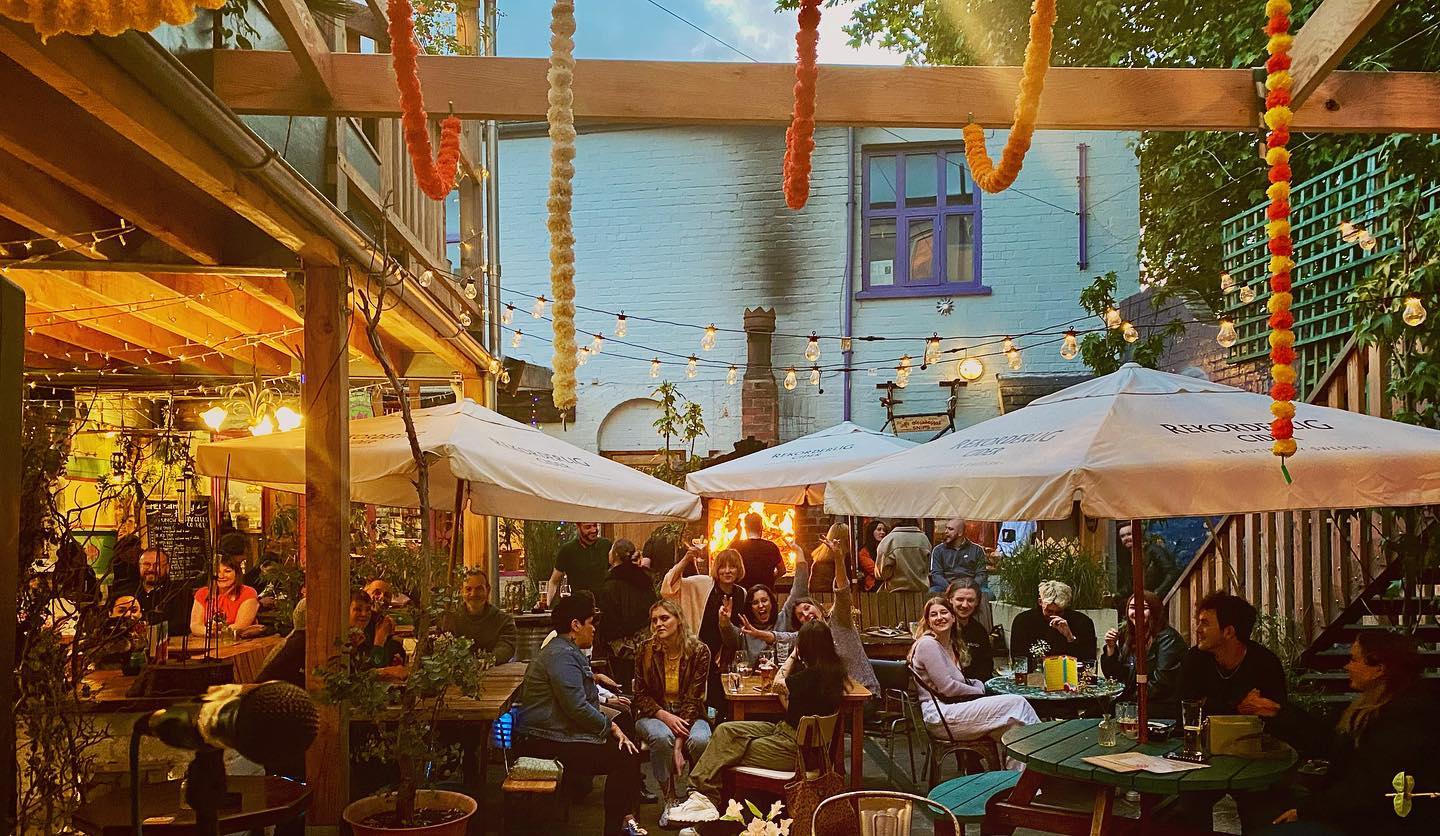 The courtyard at Haggles Coner, filled with people dining.