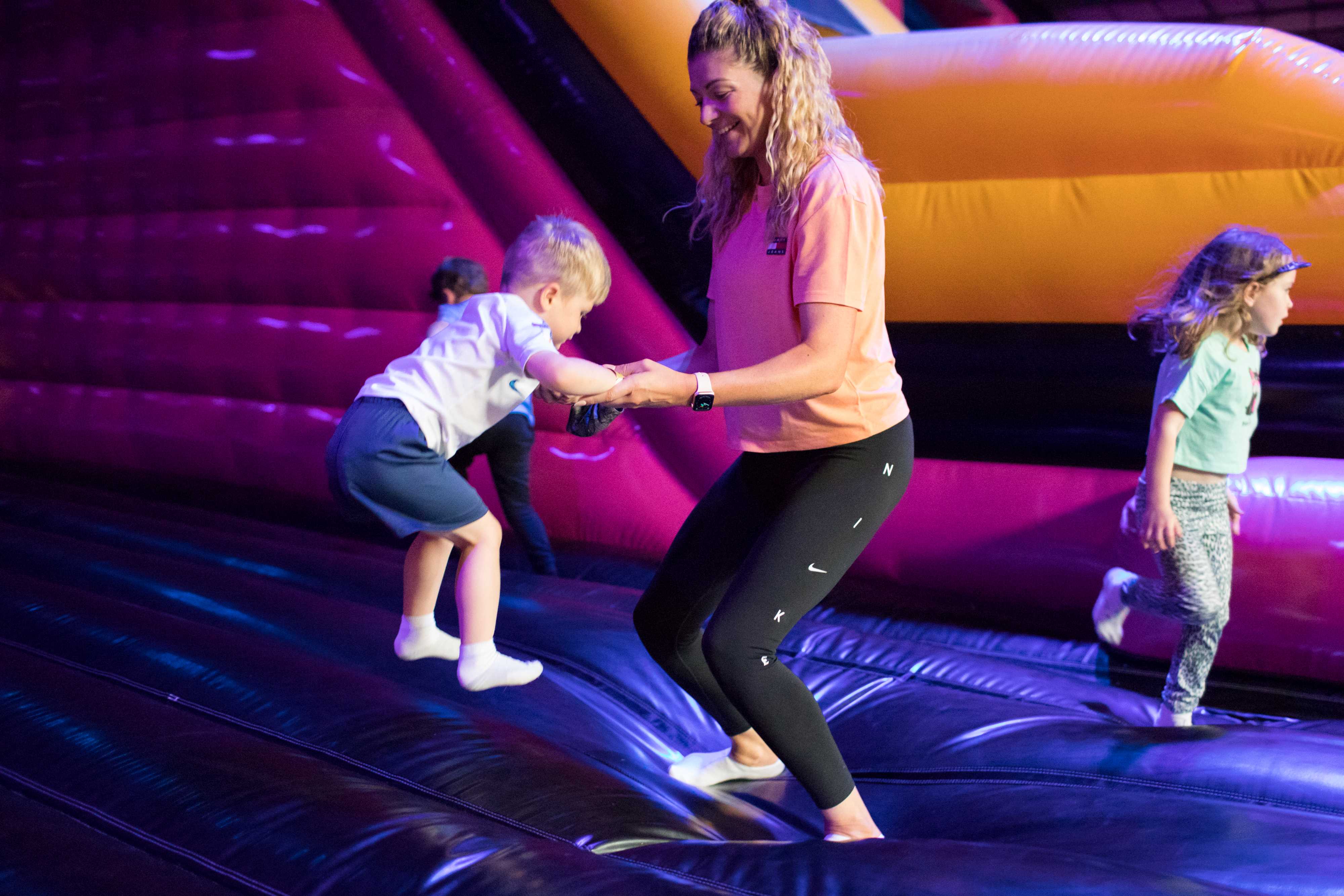 A woman and a young child jumping and having fun at Air Haus.