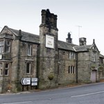 The exterior of The Fox House, a stone building with an impressive chimney stack.