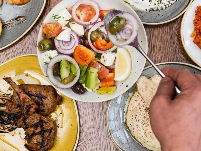 Plates of fresh Turkish food laid out on a table.