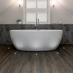 Spacious bathroom featuring a freestanding bathtub and modern fixtures.