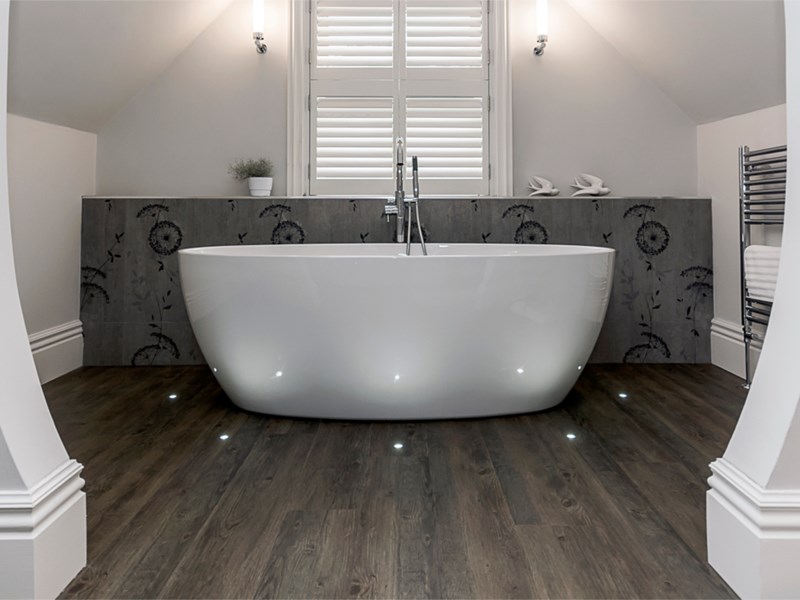 Spacious bathroom featuring a freestanding bathtub and modern fixtures.