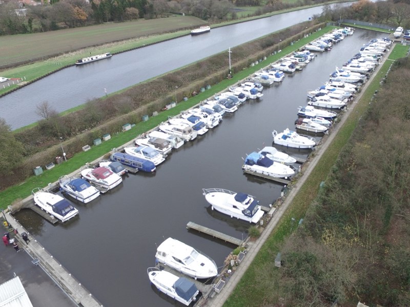 Two rows of boats in a marina.