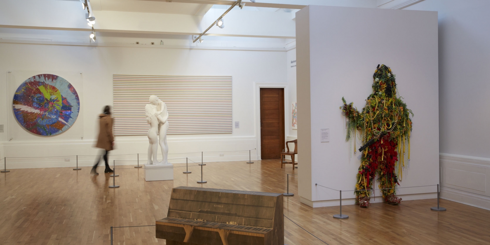 Inside Graves Gallery a woman looks at a marble statue.
