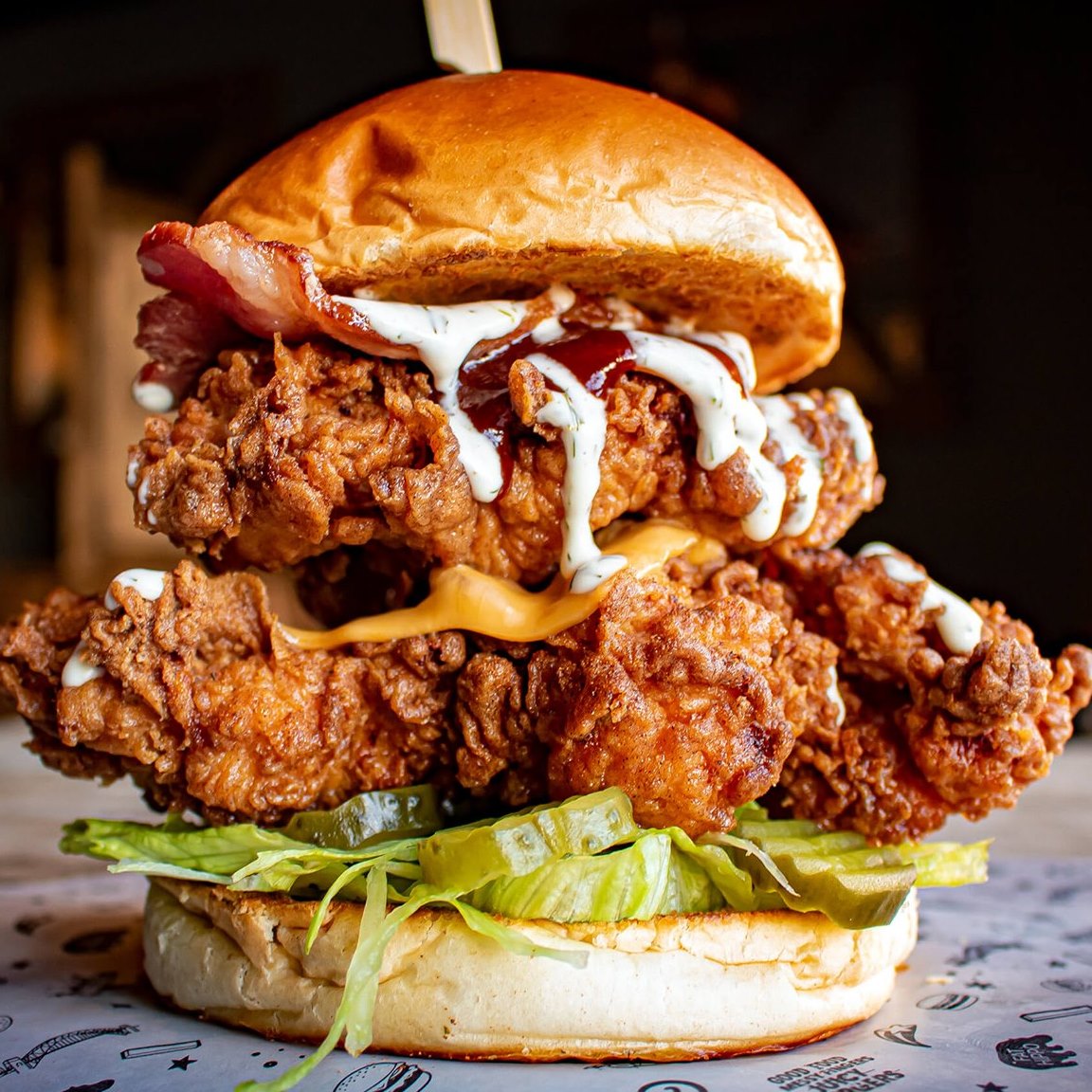 A double chicken, bacon and cheese burger.