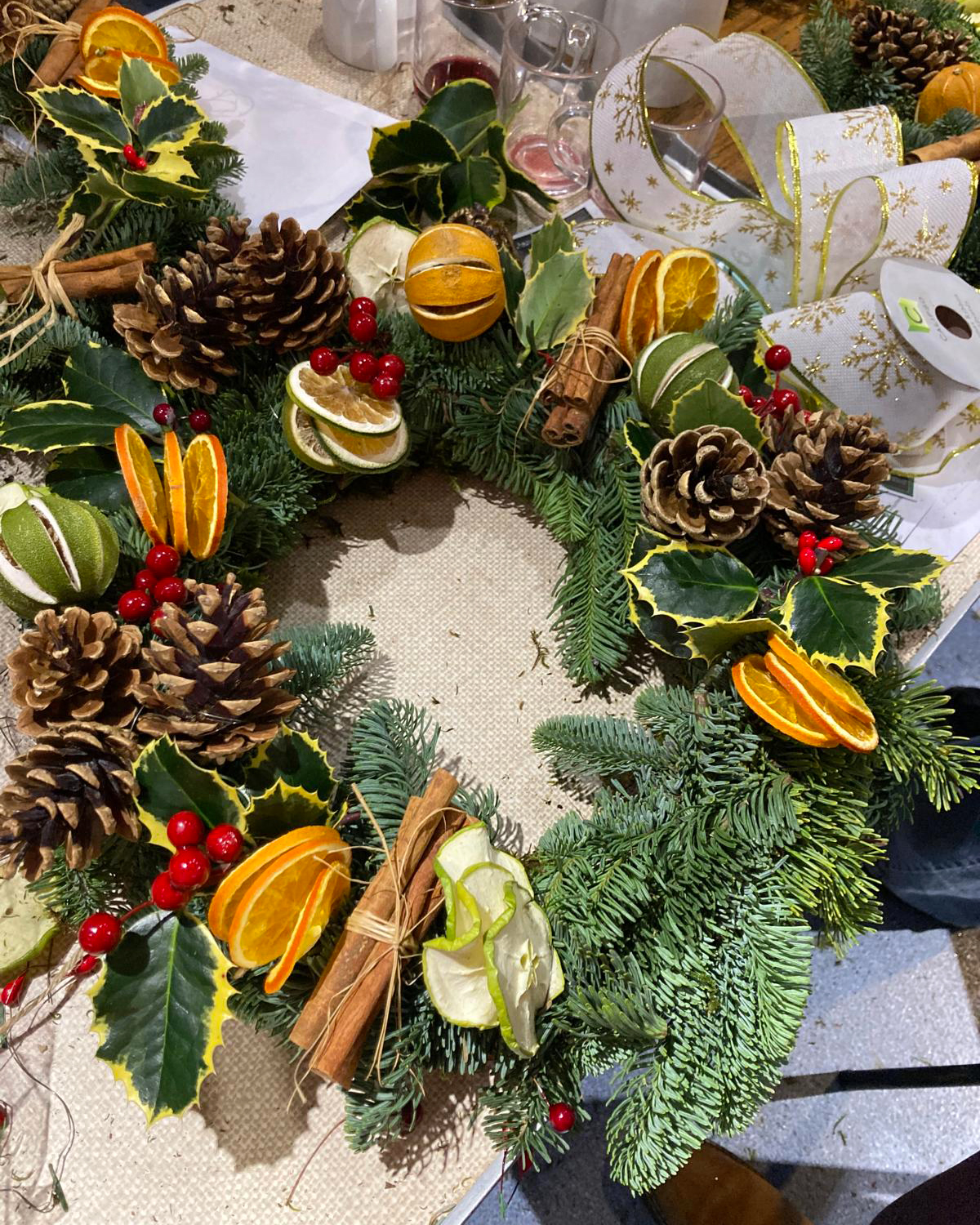 A Christmas wreath lying on a table.