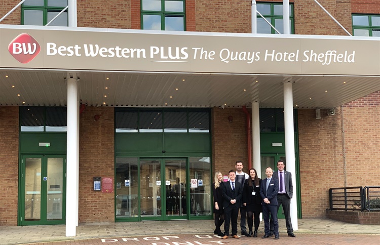 Members of staff  pose for a photo outside the entrance to The Quays Hotel.