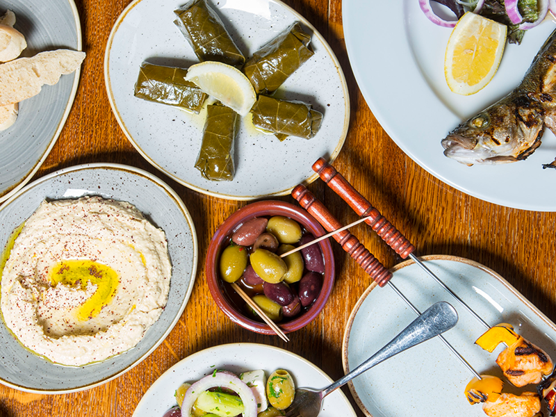 Plates of fresh Turkish food laid out on a table.