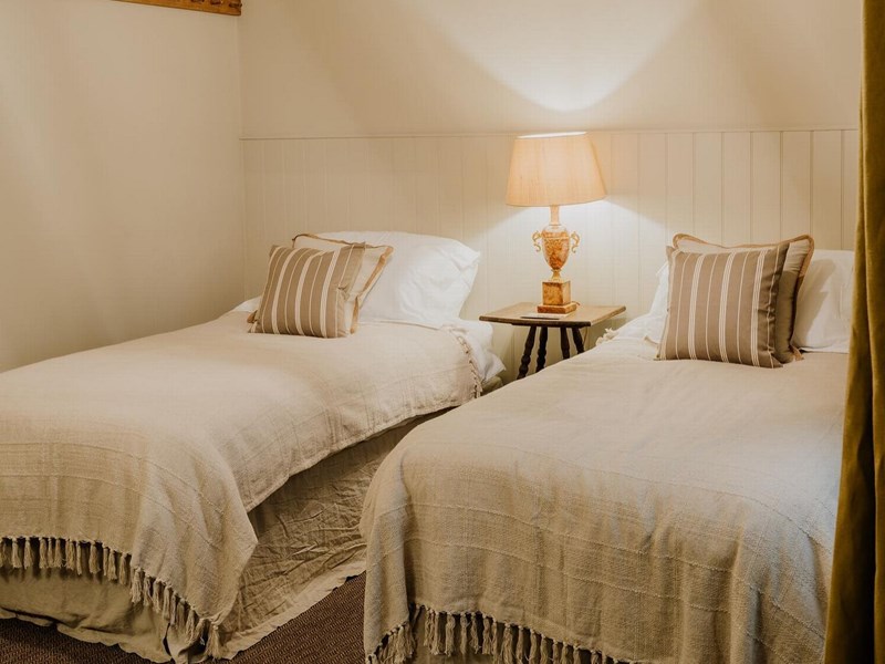 Bedroom with a double bed, bedside table, and soft lighting