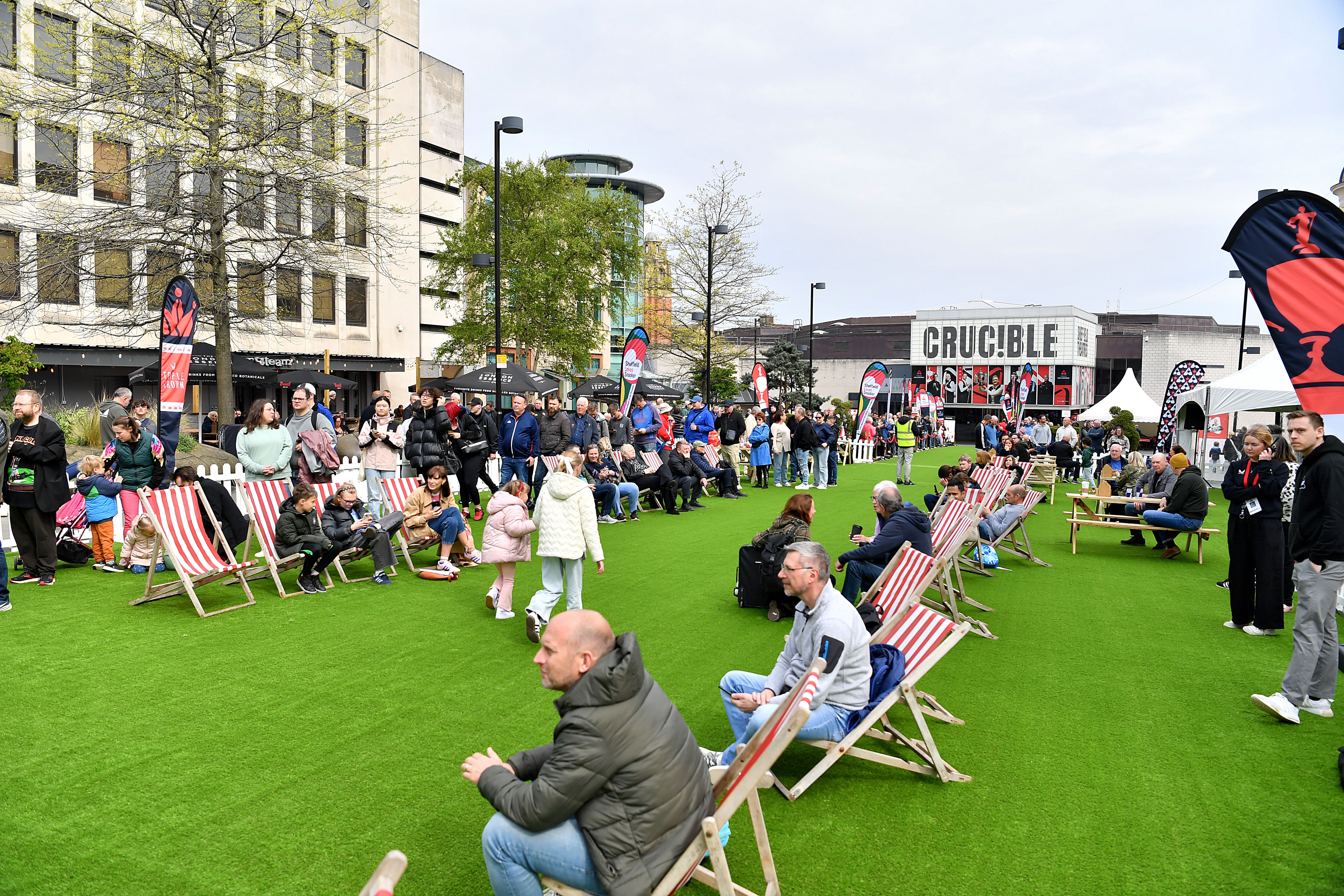 Tudor Square, in Sheffield city centre, is thronging with people, who have come to watch the snooker at The Crucible. Some people are sat on deck chairs watching the matches on a big screen.
