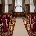 Conference room set up for a wedding with rows of chairs.
