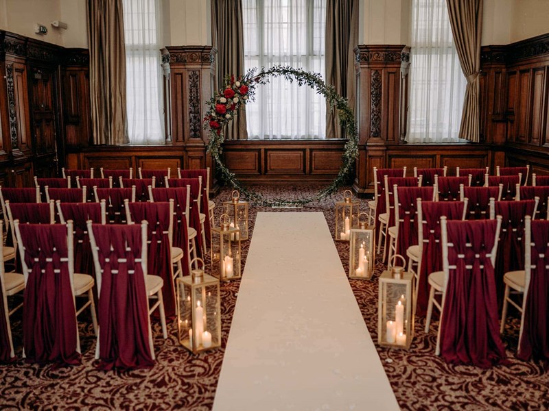 Conference room set up for a wedding with rows of chairs.