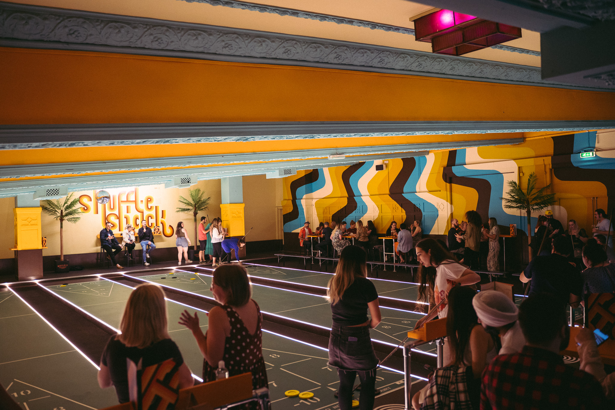 People at playing shuffleboard at Shuffle Shack at Picture House Social.