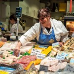 A stall holder sorting their display of fish and meat at The Moor Market.
