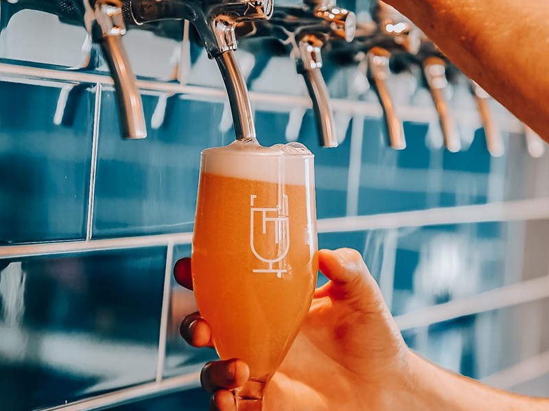 A glass of beer being poured at the Two Thirds Beer Co.
