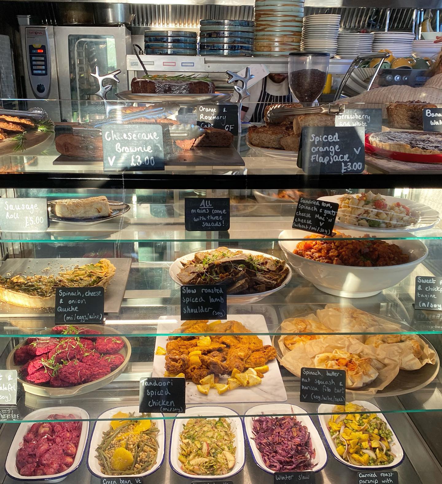 The glass counter at The Grind Café, filled with food.