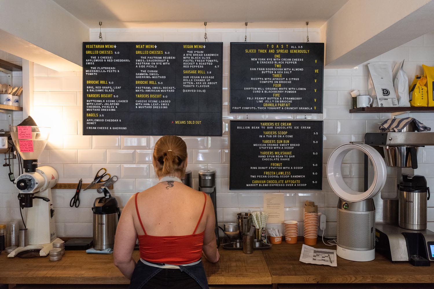 A woman prepares a coffee at Steam Yard.