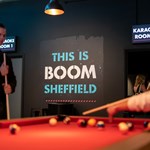 People playing pool at Boom Battle Bar.