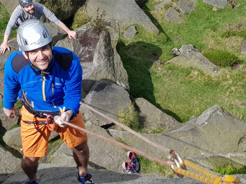 A person learning rock climbing.