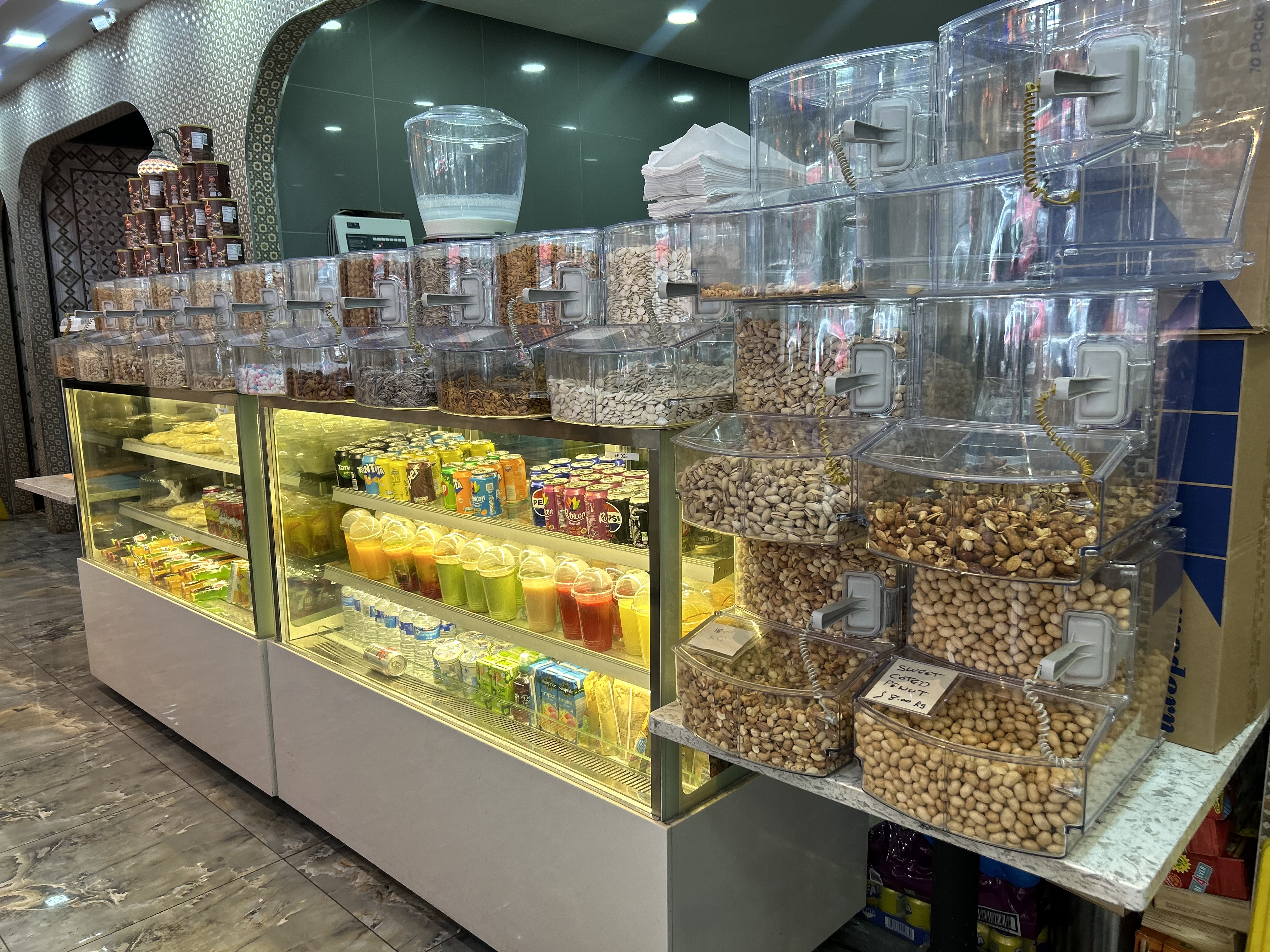A glass display of the juice and nuts selection