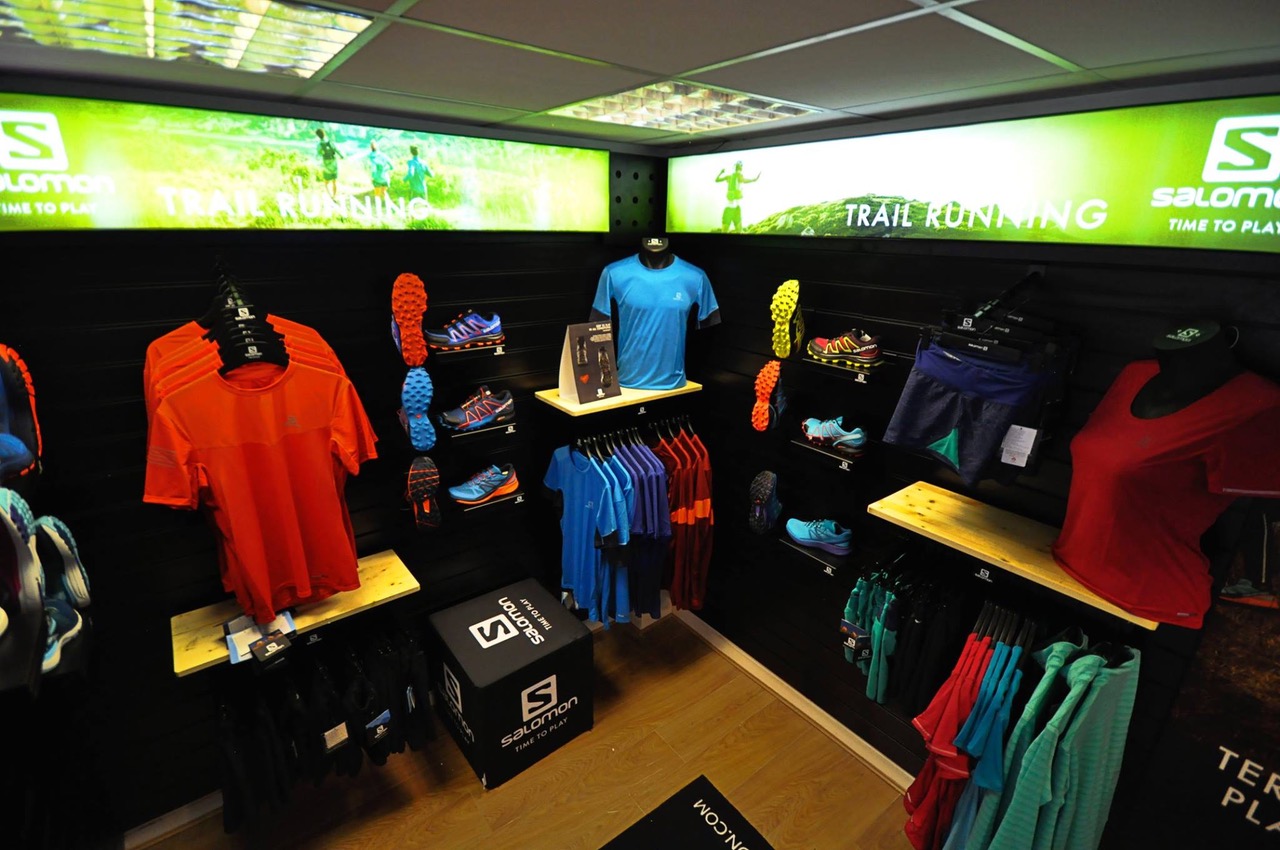 Inside the myRaceKit North shop, with lots of shelves and clothes rails full of running shoes and clothing.