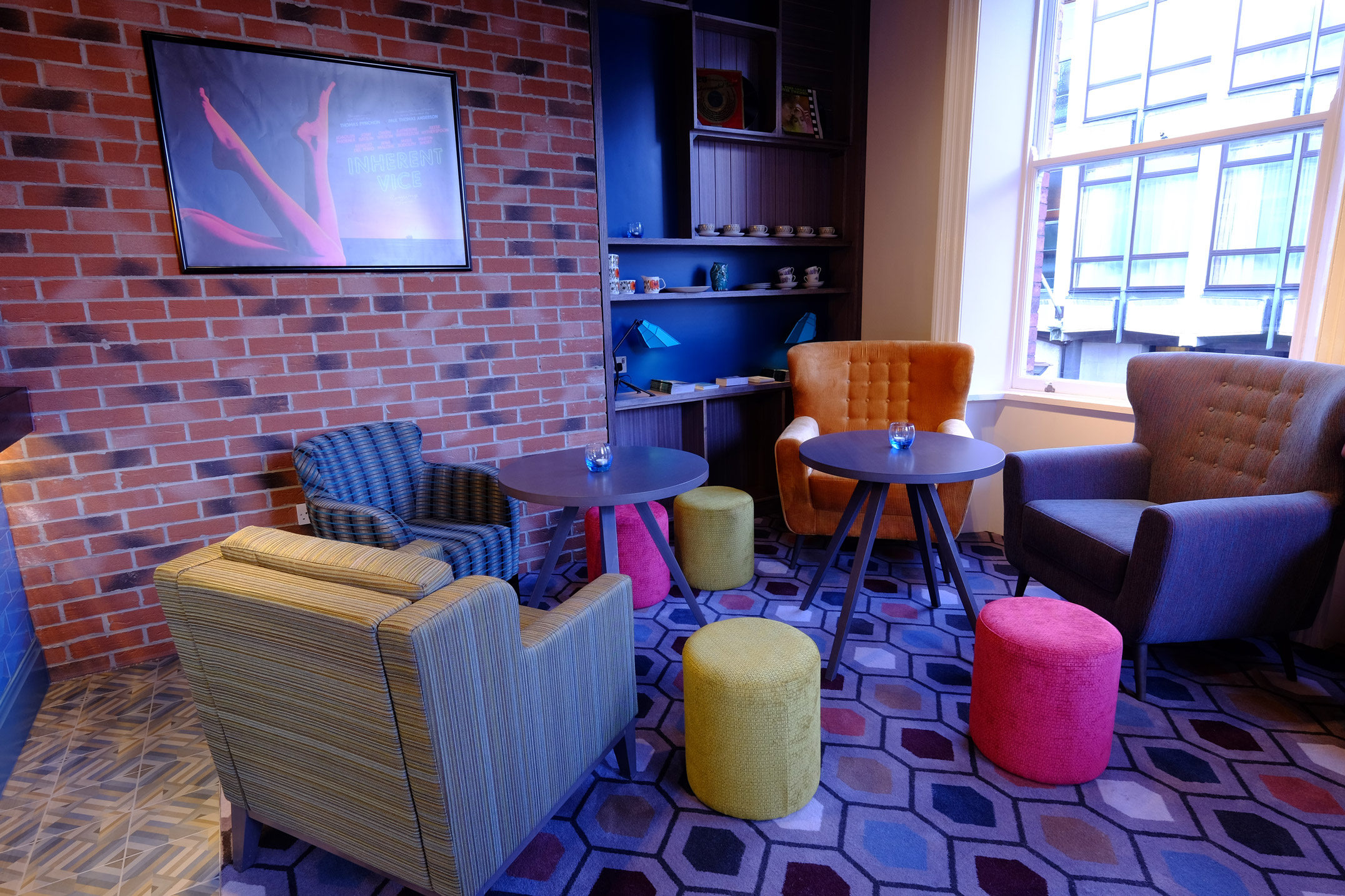A waiting area at Curzon Sheffield, with armchairs and coffee tables.