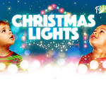 Two small children are looking in wonder at Christmas lights.