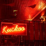 A red neon sign that reads 'Kuckoo'.