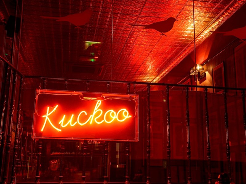A red neon sign that reads 'Kuckoo'.