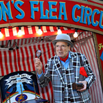 A man dressed as an old fashioned travelling showman presents Jon's Flea Circus.