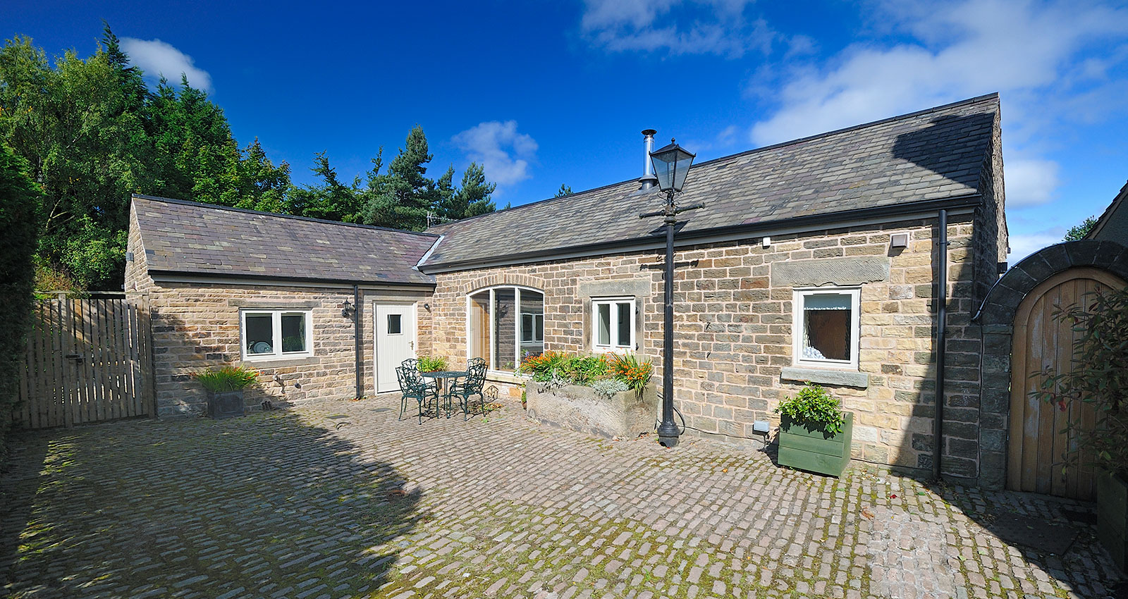 Exterior of Gooseberry Farm Cottages showing traditional stone buildings