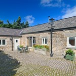 Exterior of Gooseberry Farm Cottages showing traditional stone buildings